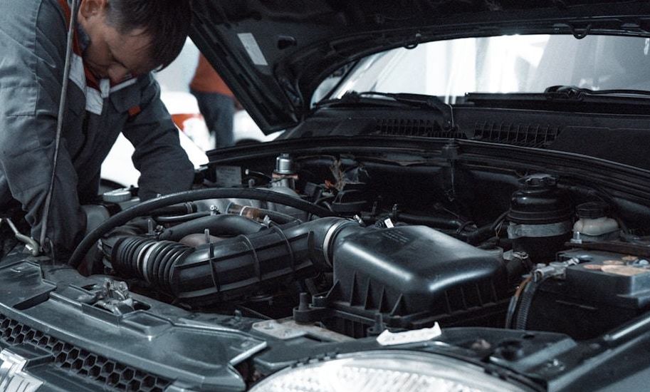 Mechanic checking the engine bay of a car