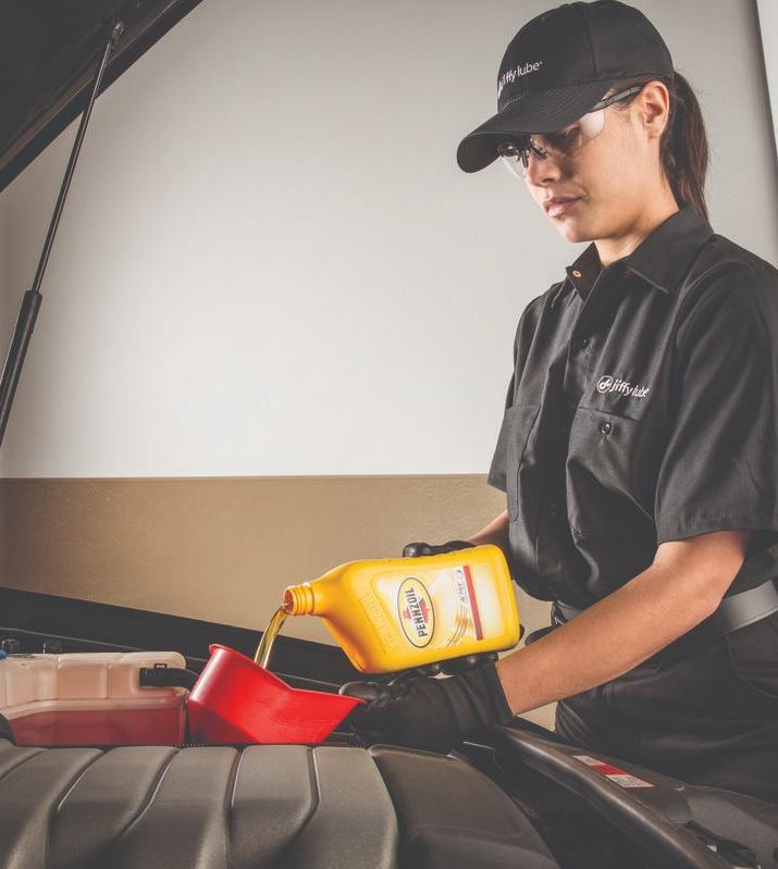 Technician checking a car in the service bay