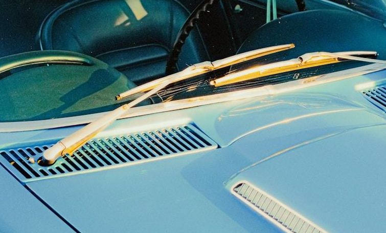 Wiper blades on a blue car windshield